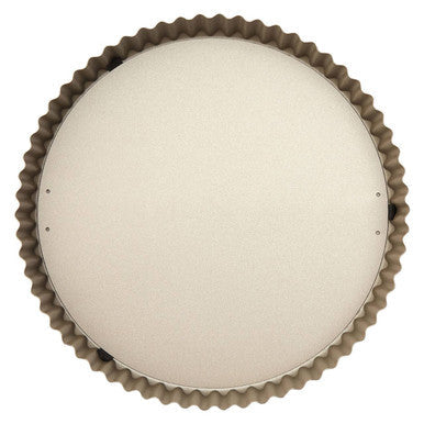 Beige circular ceiling light with textured scalloped metal frame shown with from scratch flan tin product tag