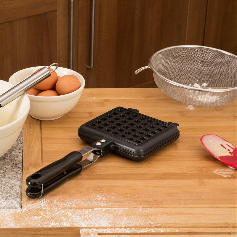 Black plastic rectangular waffle maker with grid pattern and handle for easy gripping from scratch waffle maker