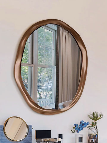 Bronze-finished fronchi mirror with an irregular oval shape and a modern sculpted frame for stylish wall decor