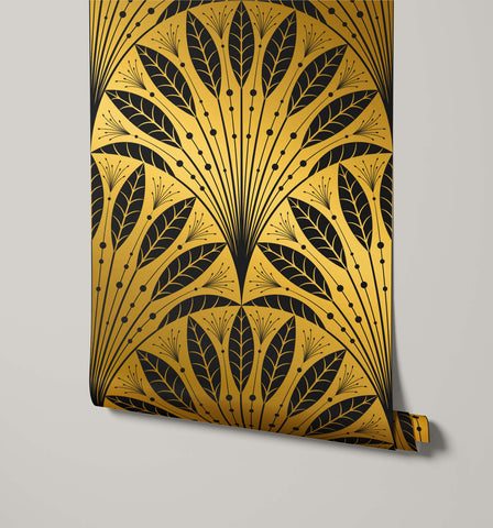 A roll of gold and black art deco wallpaper with stylized leaf motifs called frond for stylish wall decor