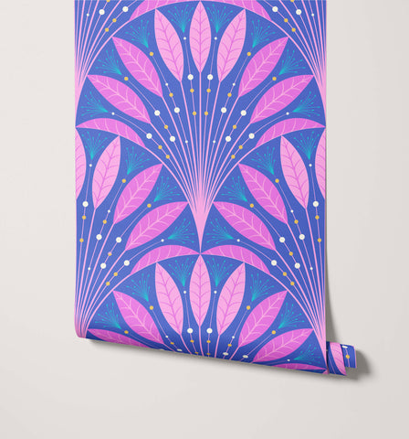A roll of frond art deco wallpaper with pink and blue leaf patterns and gold dot accents in a symmetrical design