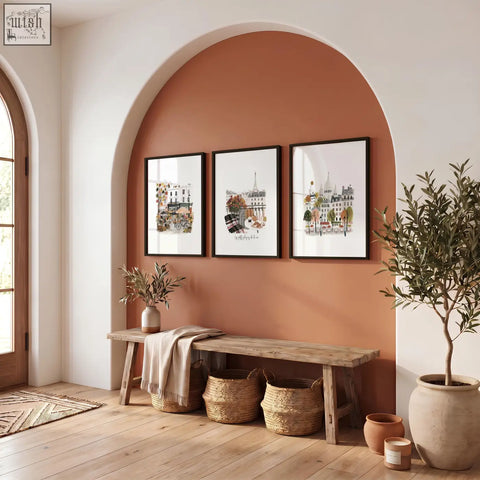 Three parisian-themed art prints hang above a rustic wood bench on a terracotta wall for cozy room pictures wall art