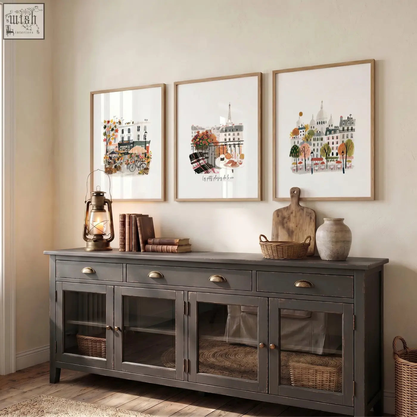 Gray distressed wood sideboard with glass paneled doors and brass handles shown with paris eiffel tower autumn wall art prints