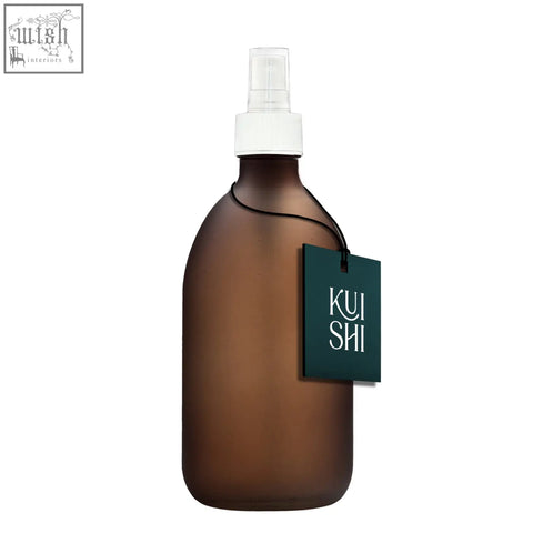 A sleek frosted amber glass atomiser spray bottle with white nozzle and cap for easy misting