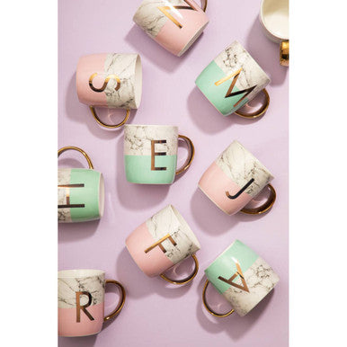 Pastel pink and mint green ceramic monogram mugs with frosted deco marble effect and gold lettering