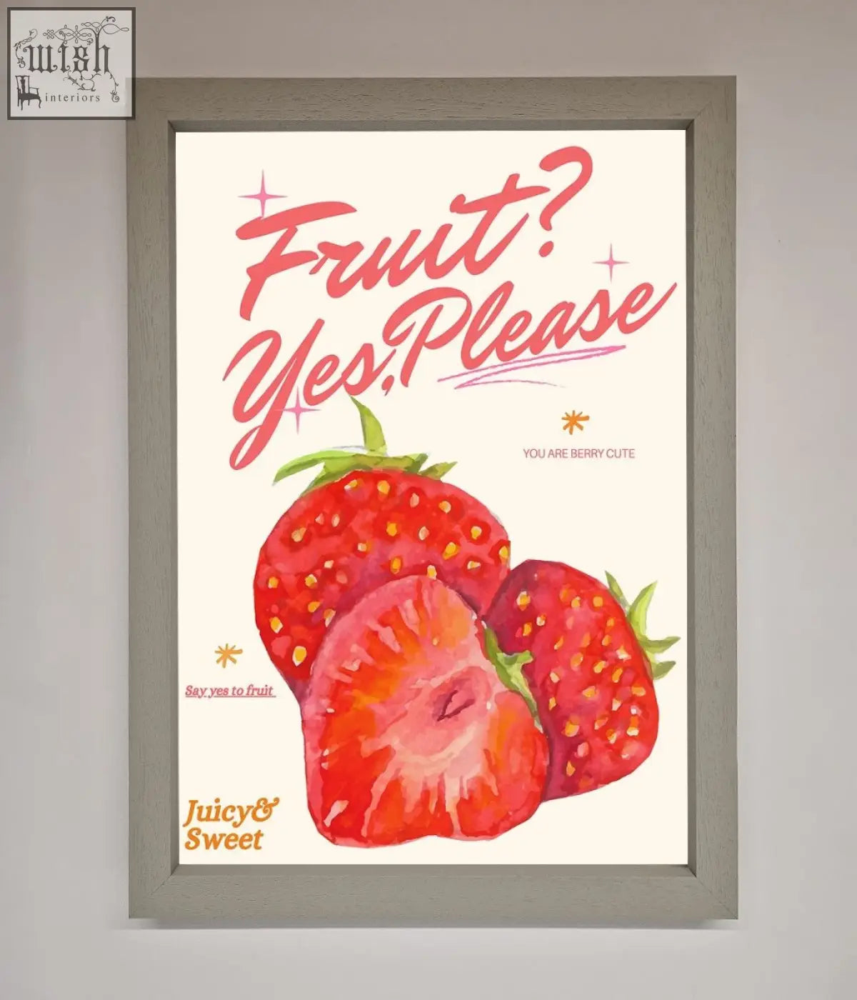 A framed poster featuring vibrant red strawberries with green tops and playful pink text fruit yes please