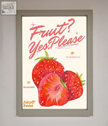 A framed poster featuring vibrant red strawberries with green tops and playful pink text fruit yes please