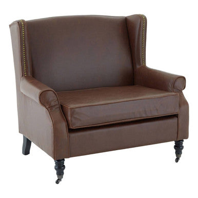 Fulham brown leather effect wing armchair with brass nailhead trim and dark wooden legs in brown leather