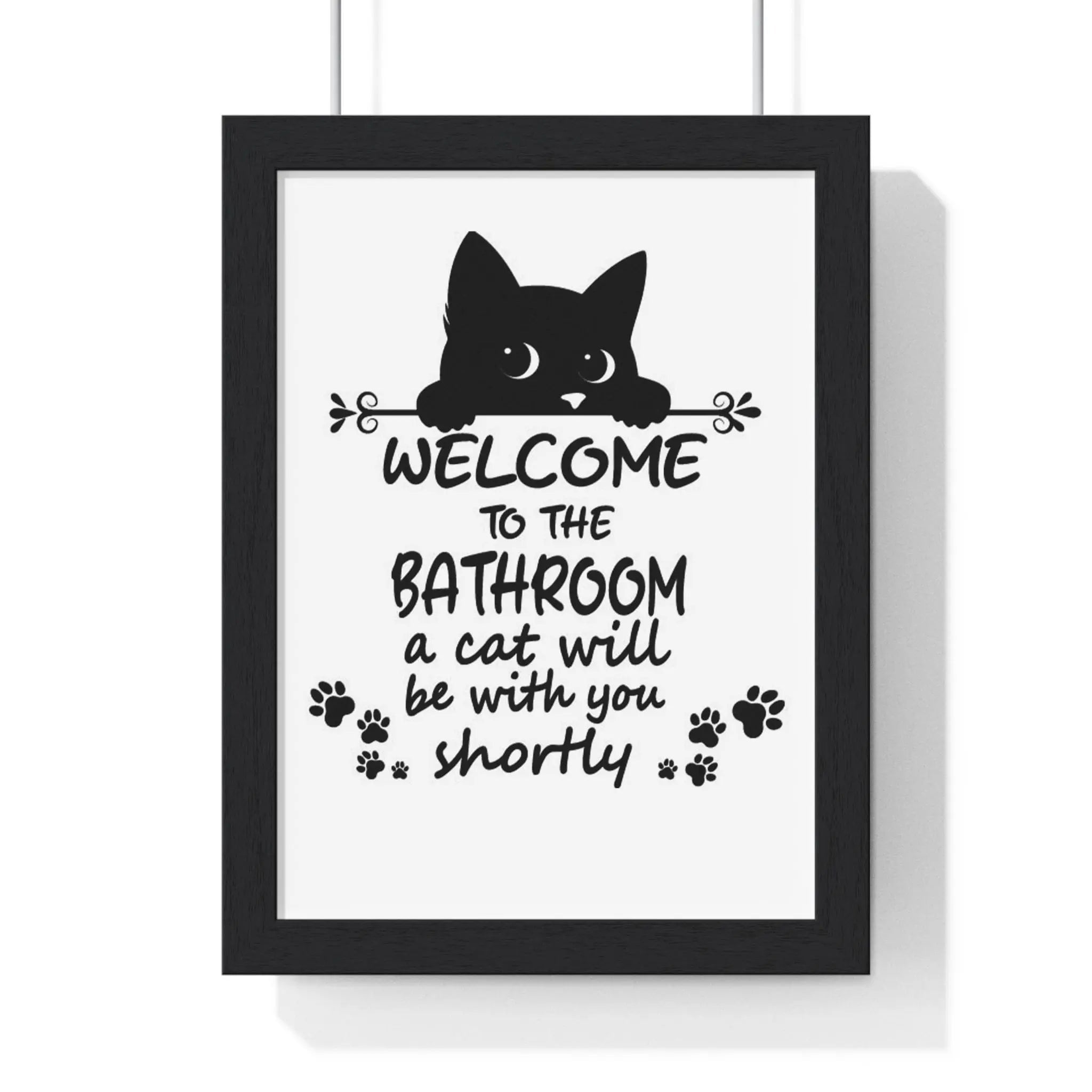 Funny cat bathroom print black-framed wall art with cat silhouette welcome text and paw prints on white background