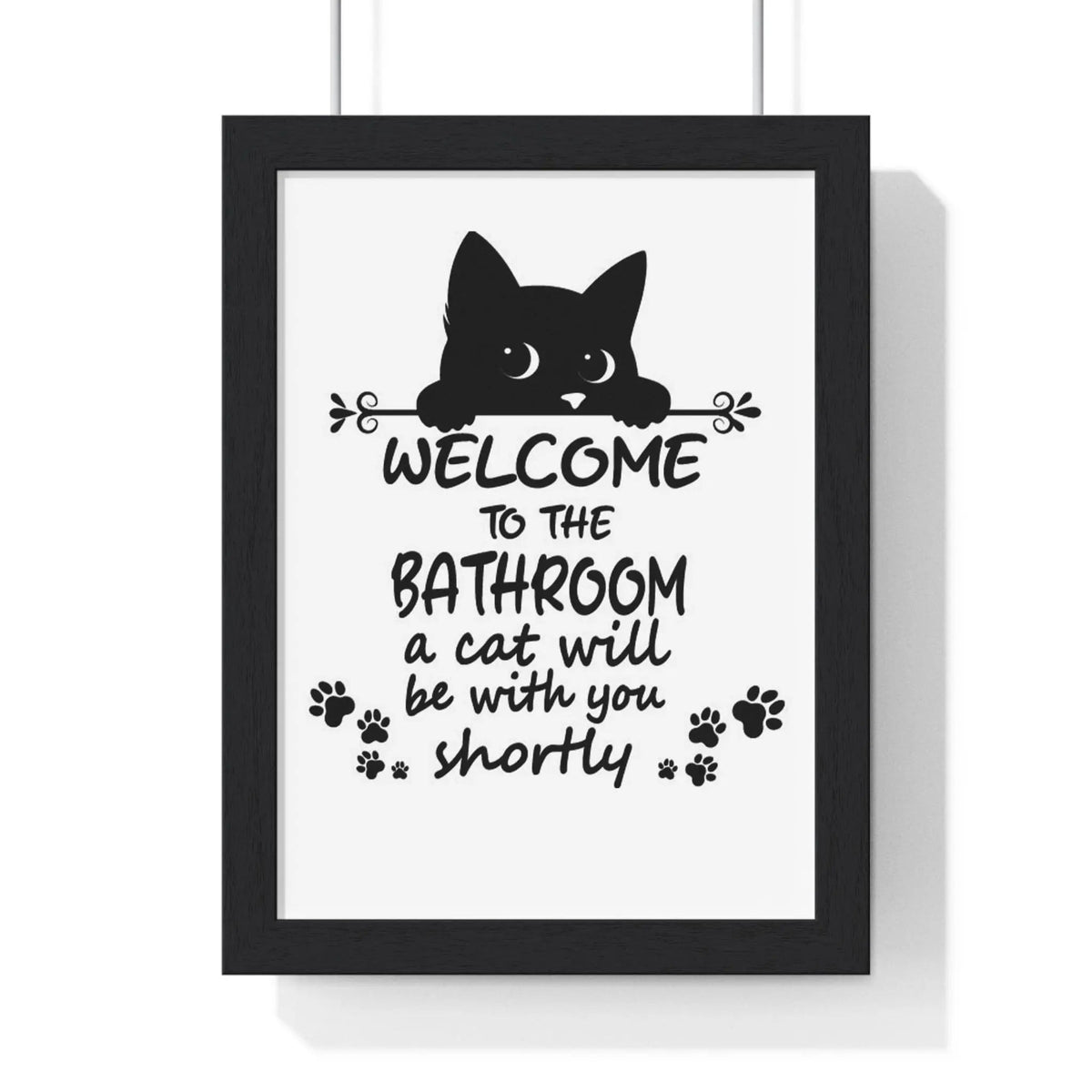 Funny cat bathroom print black-framed wall art with cat silhouette welcome text and paw prints on white background
