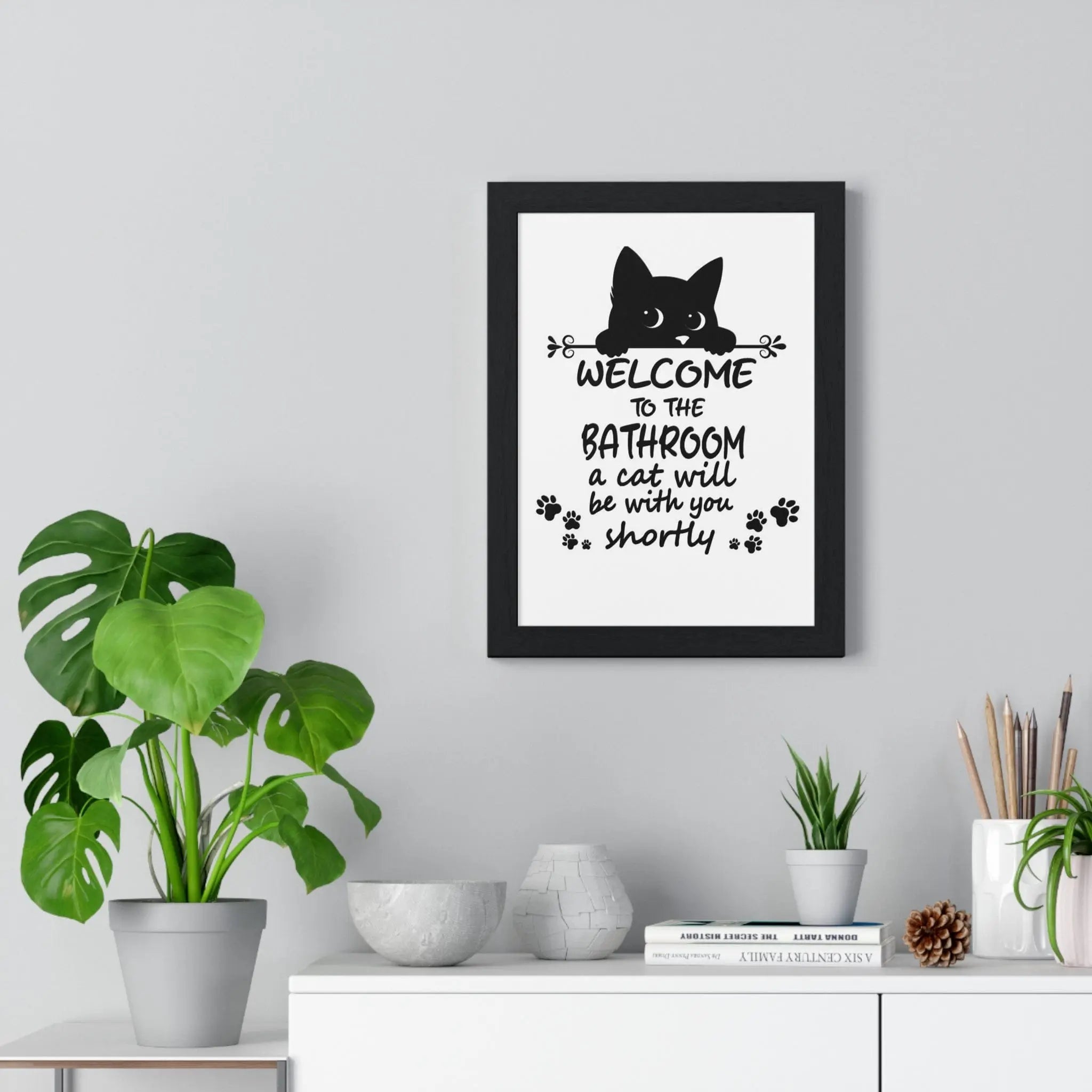 Black-framed funny cat bathroom wall art with a cat silhouette and welcome to the bathroom text print
