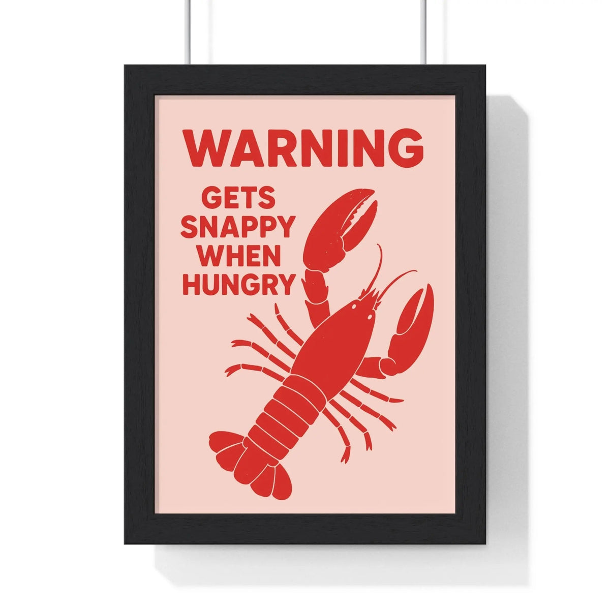 A funny lobster print framed poster with a bold red lobster and snappy when hungry text on soft pink background