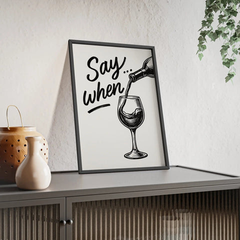 Black-framed wine poster with a sketch of wine being poured and funny say when text for kitchen and bar decor
