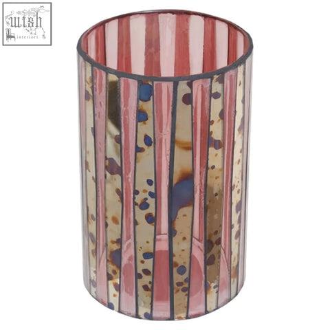 A large gaia pink mosaic candle holder with vertical pink and gold stripes and blue splatter accents