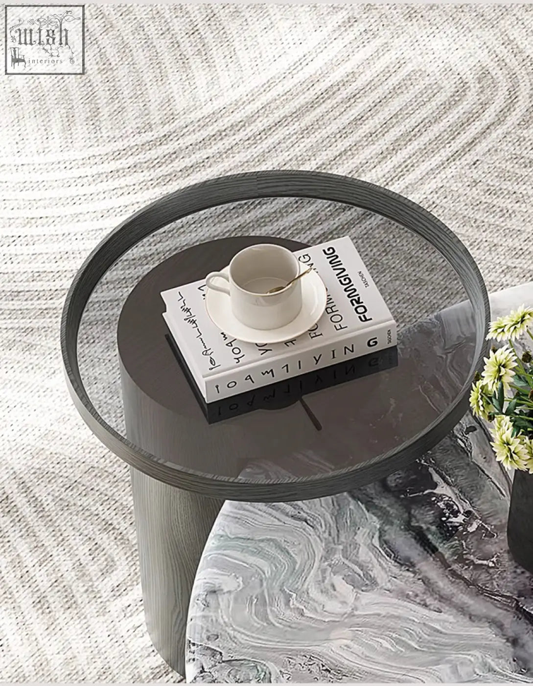 Modern round marble coffee table with a dark gray wood-grain textured base and glass top for stylish living rooms