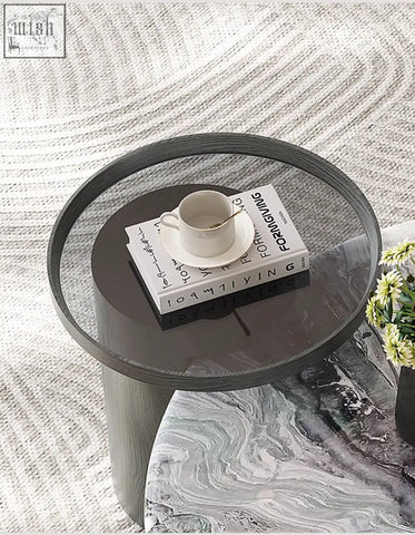 Modern round marble coffee table with a dark gray wood-grain textured base and glass top for stylish living rooms