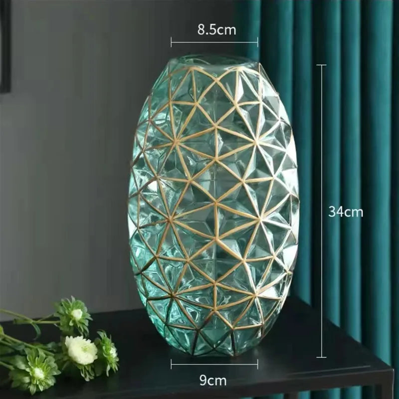 A tall translucent teal glass galato vase with geometric lattice pattern and gold metal framing