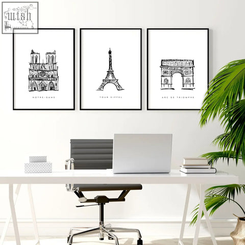 Three black-framed minimalist line art prints of paris landmarks wall art hang above a white desk for gallery wall framing