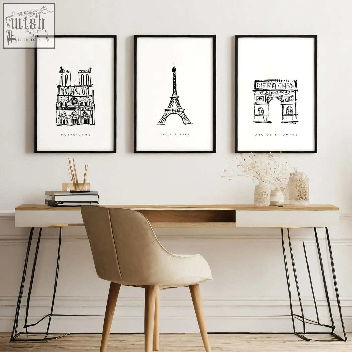 Three black-framed minimalist line art prints of paris landmarks hang above a modern desk as paris landmarks wall art