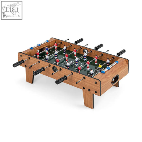 Wooden football table with black handles and colorful players in red white blue and yellow for game room space saving use