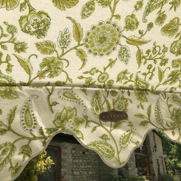 Cream-colored garden umbrella with hand block printed olive green floral paisley canopy and scalloped edge by titania