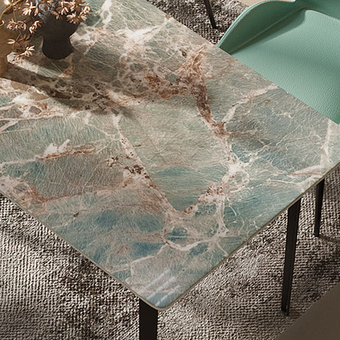 A gareth dining table with a polished green marble top and carbon steel black metal legs for stylish dining