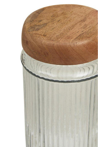 Clear glass canister with vertical ridges and a round mango wood lid for stylish kitchen storage