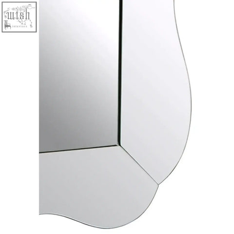Curved-edged gavri wall mirror with a sleek minimalist design and reflective surface for stylish wall decor