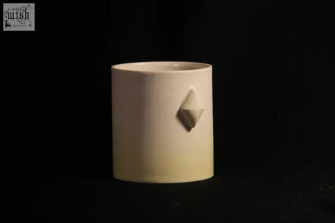 Cream-colored ceramic gem mug features five subtle three-dimensional diamond-shaped reliefs on its side