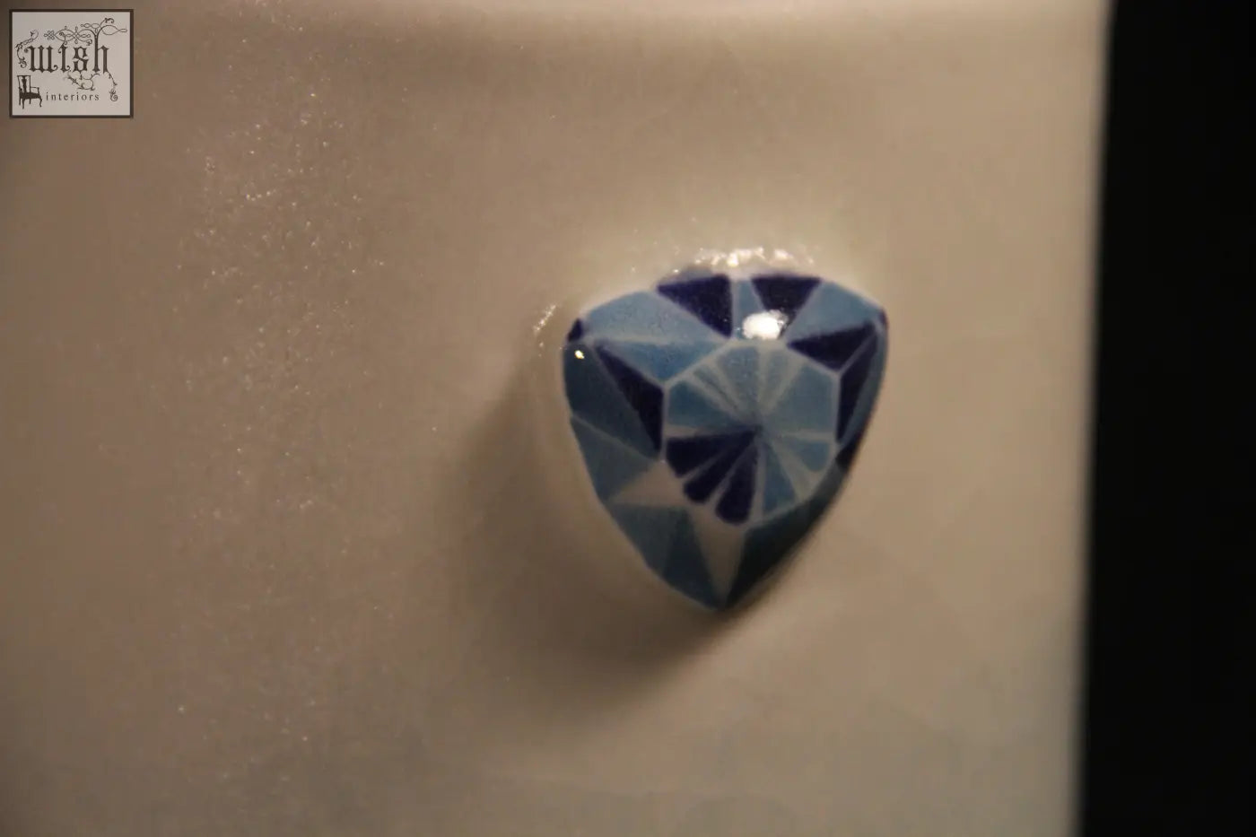 A faceted blue heart-shaped gemstone featured on the gem mug showcases the mug features five unique designs