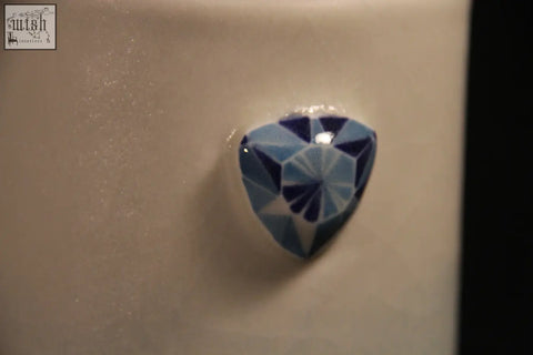 A faceted blue heart-shaped gemstone featured on the gem mug showcases the mug features five unique designs