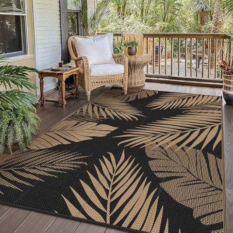 Black genimo outdoor rug extra large waterproof with bold golden brown tropical leaf pattern perfect for patio and backyard