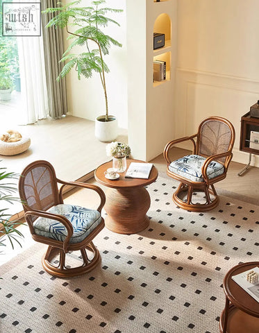 Pair of gentry swivel rattan wooden armchairs with woven backrests and blue leaf-patterned cushions perfect for lounge use