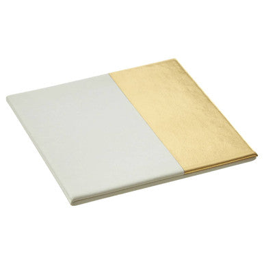 A sleek minimalist notebook with a two-tone matte white and metallic gold cover matching geome set square white gold coasters