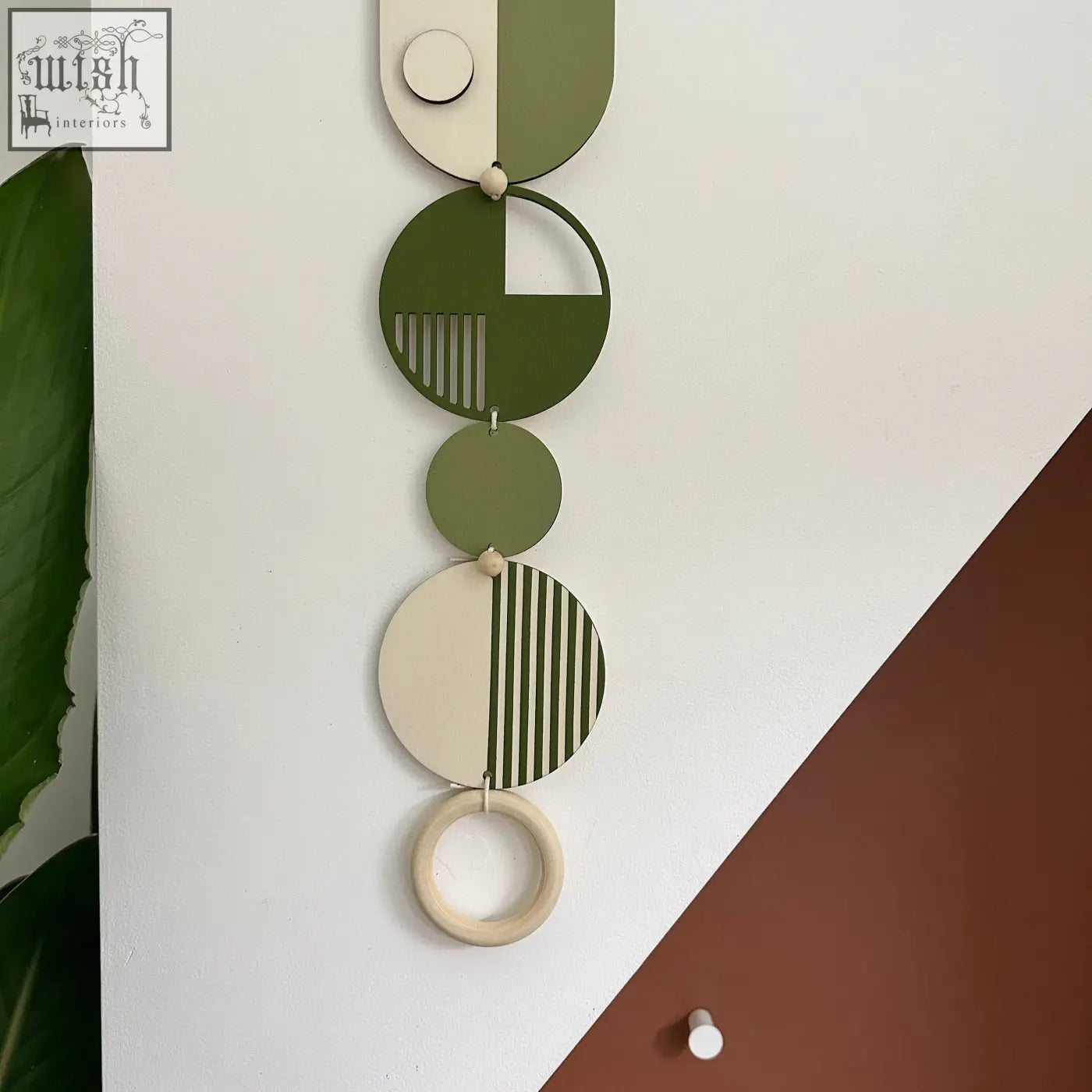 Olive and cream modern wall art with geometric discs and wooden beads made of sustainable plywood for minimal home decor