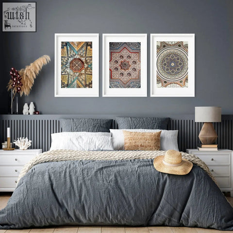 A woven straw hat with a beige band rests on the bed near geometric patterns art prints for bedroom wall art prints