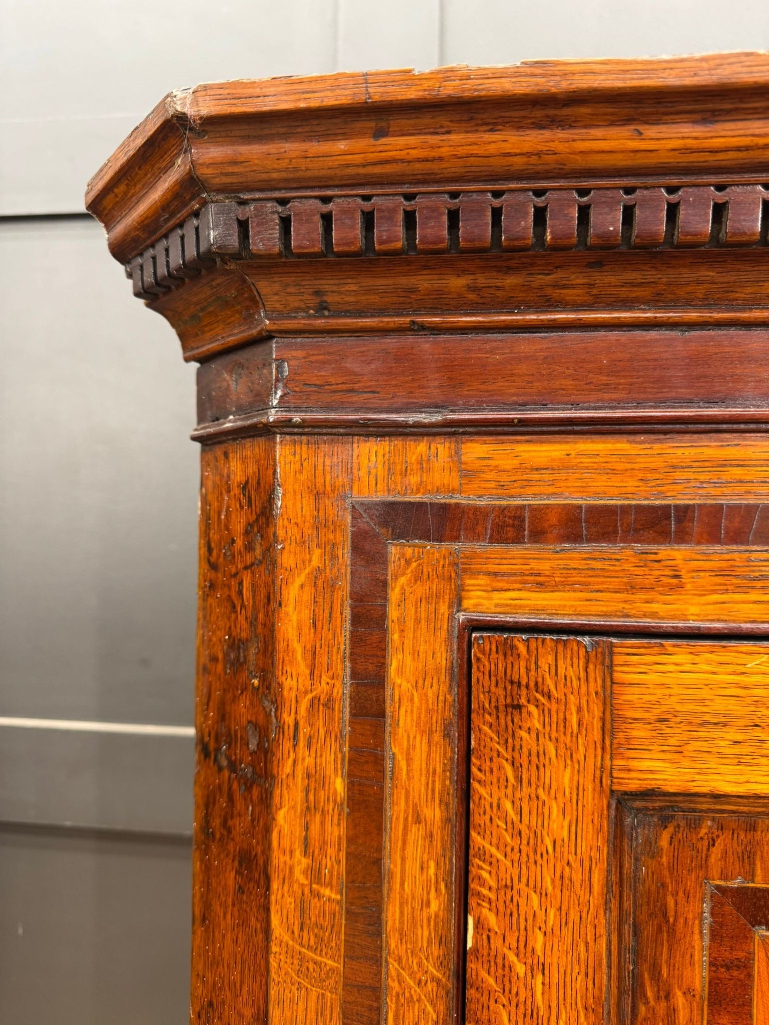 Antique genuine georgian oak corner cupboard with intricate inlaid woodwork and warm amber finish for hall storage