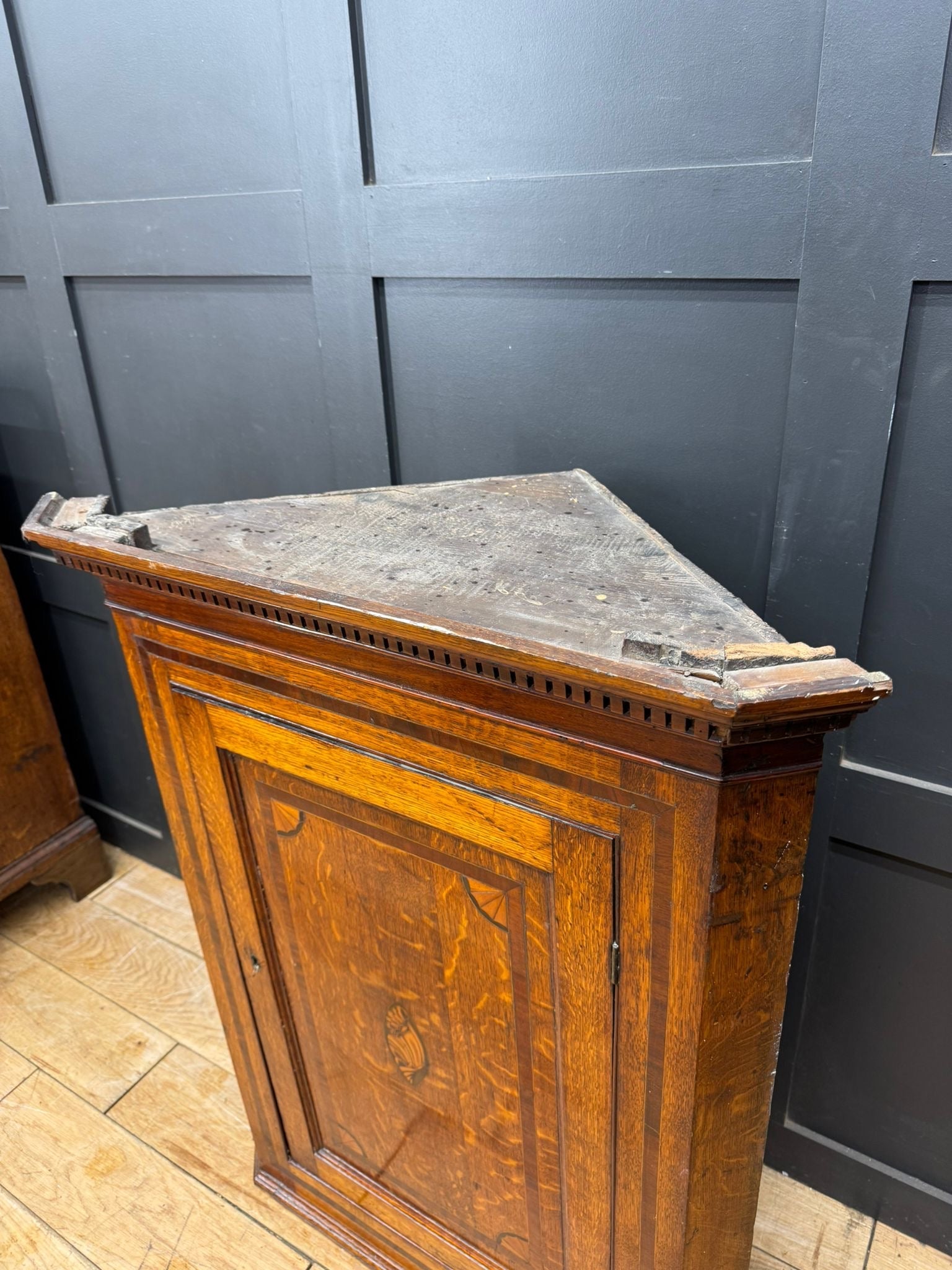 Genuine georgian oak corner cupboard with worn darkened top and intricate wood grain for hall storage