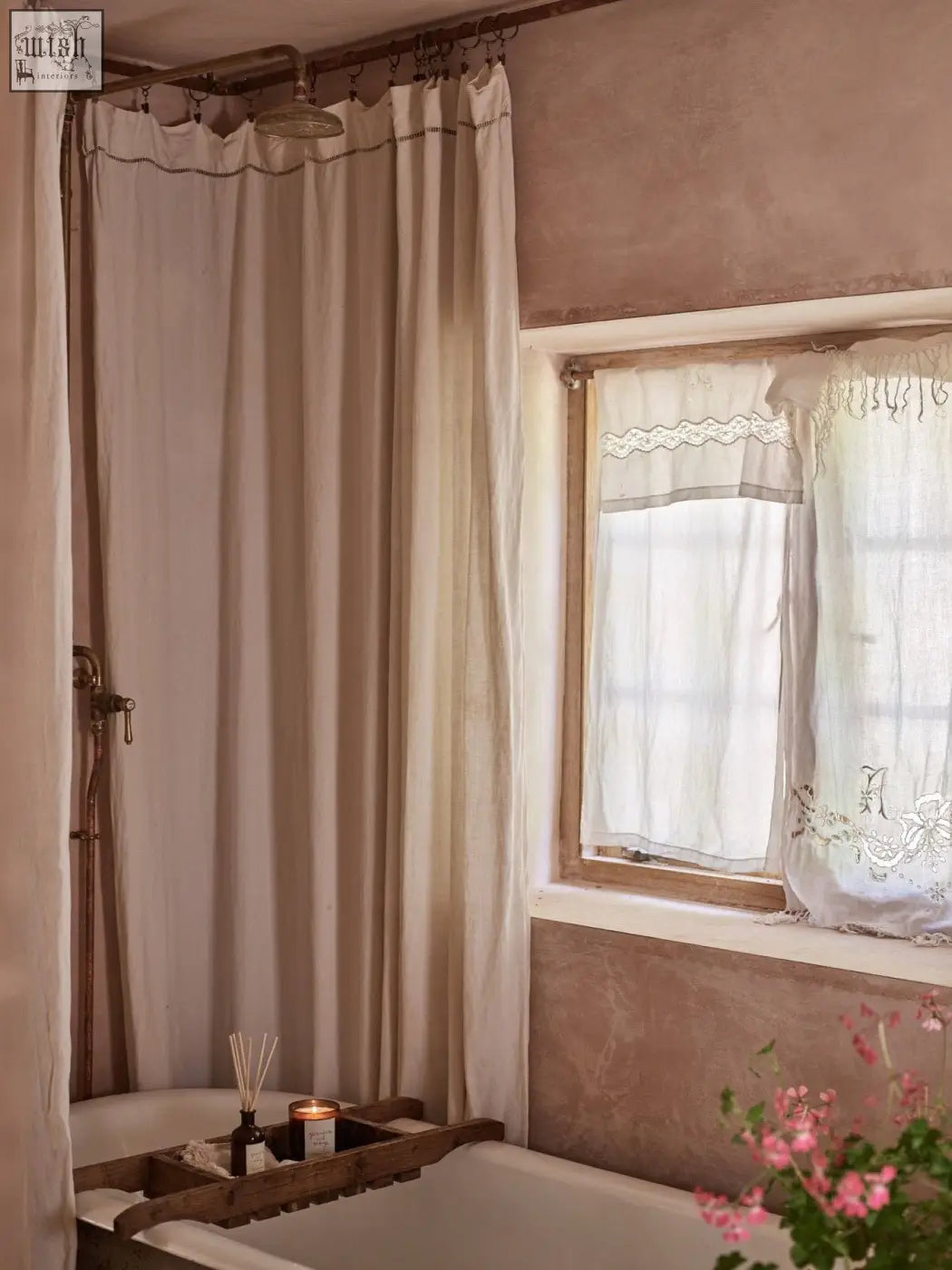 Beige linen shower curtain with delicate lace trim and scalloped edge complements geranium and orange diffuser with vegetable oil base