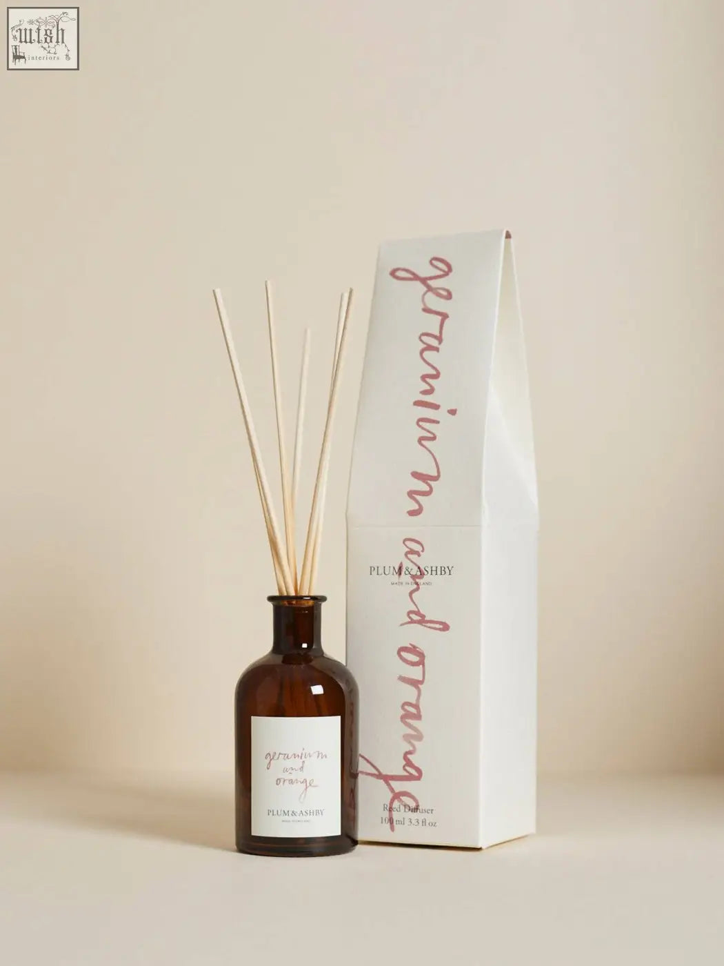 Brown glass geranium and orange diffuser with wooden sticks and plum and ashby label using vegetable oil base
