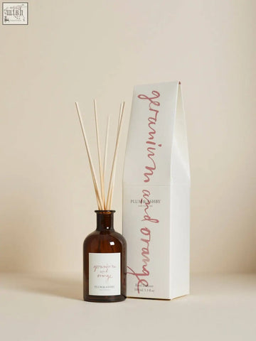 Brown glass geranium and orange diffuser with wooden sticks and plum and ashby label using vegetable oil base