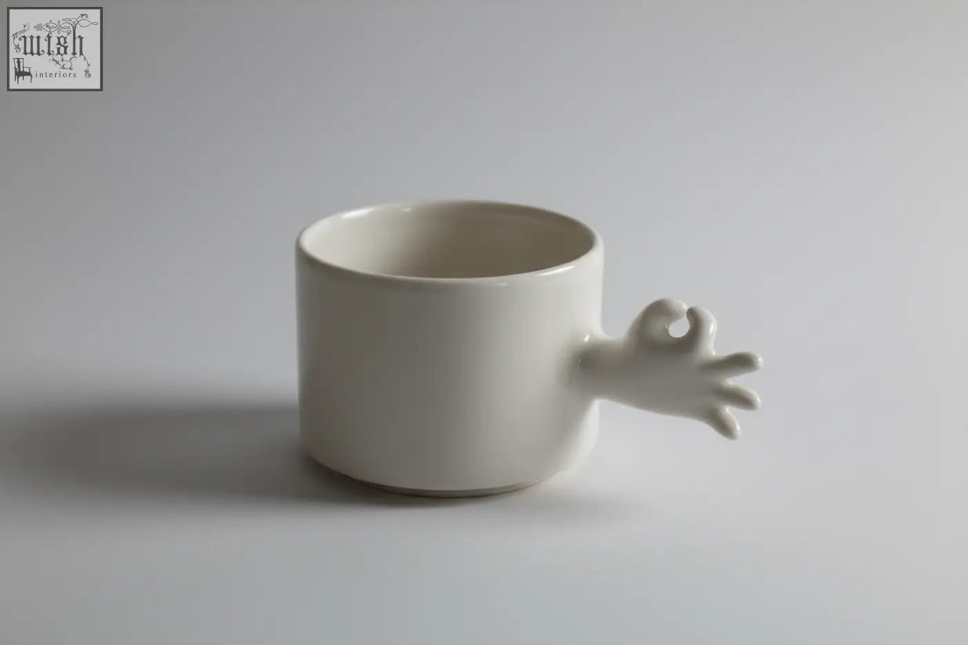 White ceramic mug from 4am product design cups series with a sculpted okay hand handle handmade porcelain coffee cup