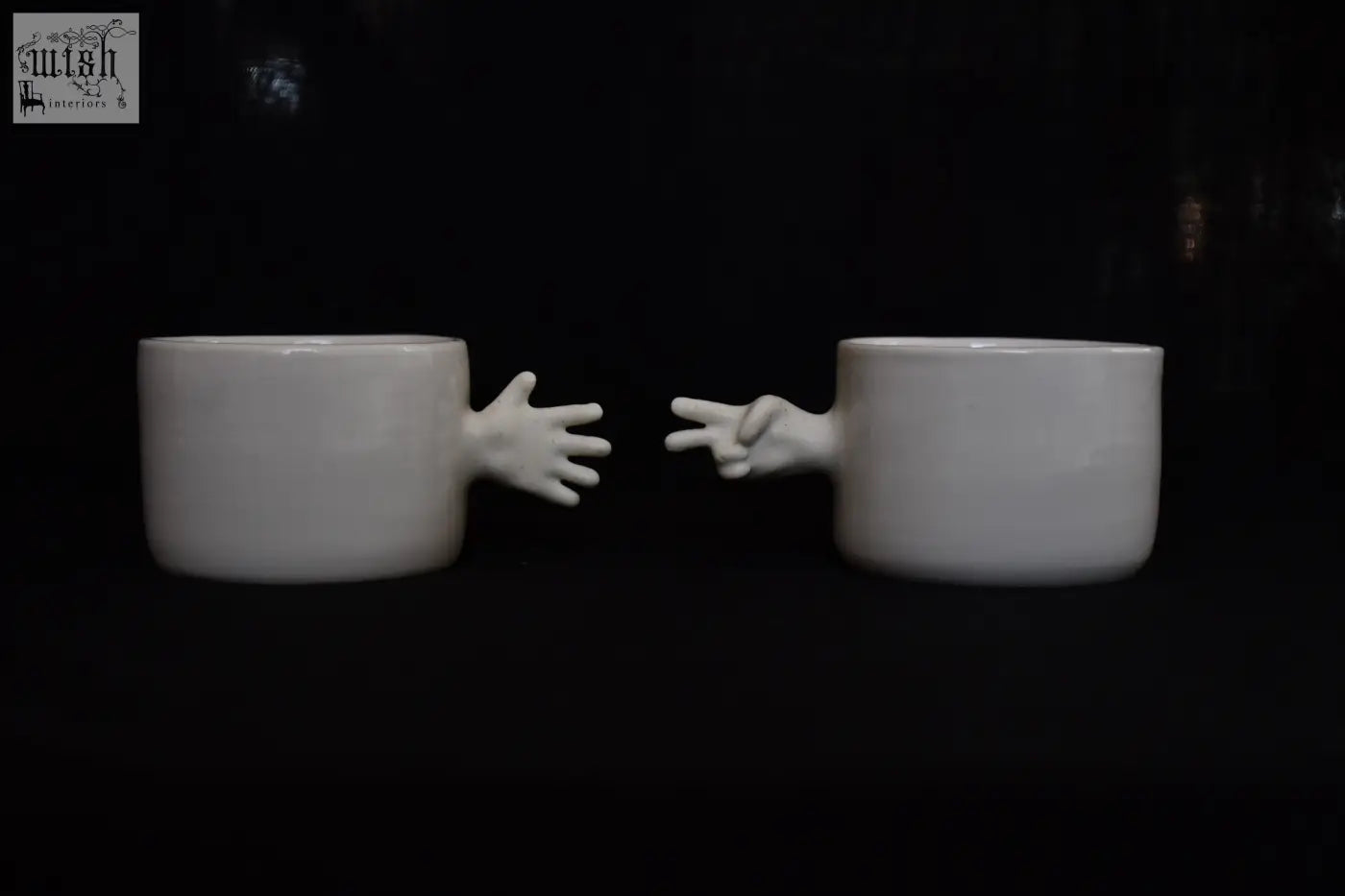 White ceramic porcelain coffee cups with sculpted hands making peace sign and open palm by 4am product design