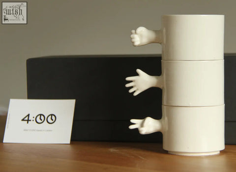 White ceramic stacking mug with sculpted hands from gesture ceramic cups set handmade porcelain by 4am product design