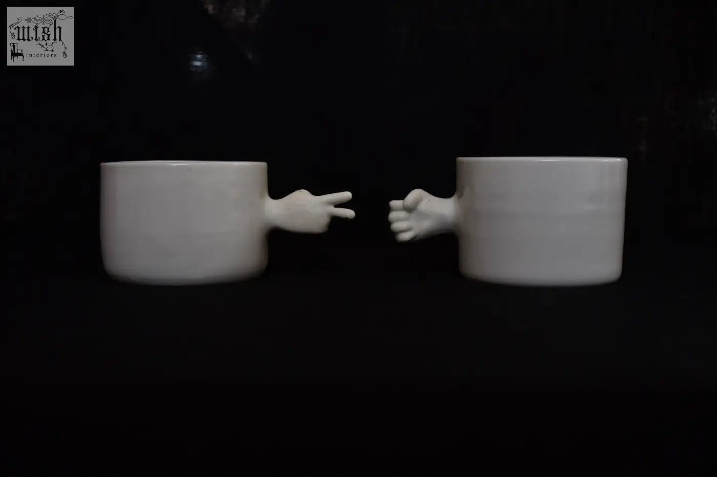 White ceramic gesture cups with sculpted hands showing peace sign and fist handmade porcelain 4am product design
