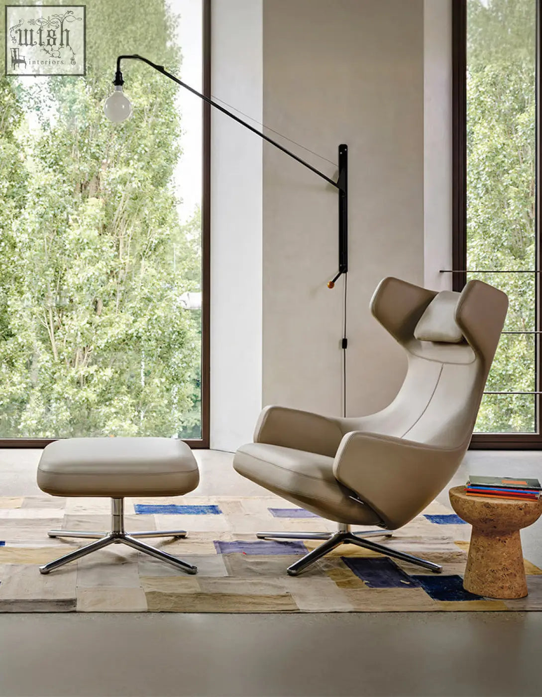 Beige leather wingback lounge chair with chrome base egg chair and matching ottoman for relaxing seating