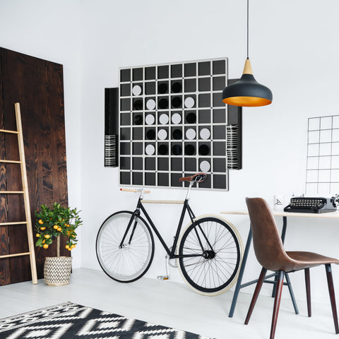 Black and white giant reversi game board with wooden handlebar grip showing opponents stones and age range info