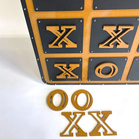 Wooden giant xox board tic tac toe game with black and gold cut-out xs and os on a stylish grid