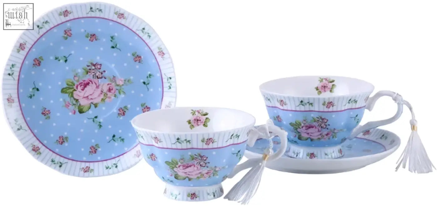 Delicate porcelain tea set with blue rose patterned cups saucers and milk jug on a special 3 tier cake stand