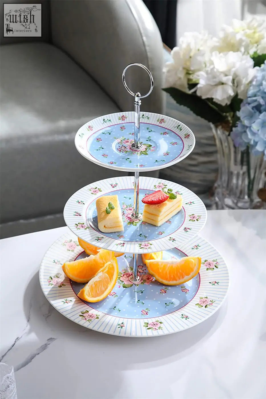 Three-tiered light blue porcelain tier cake stand with pink floral patterns and silver ring handle gift set with milk jug